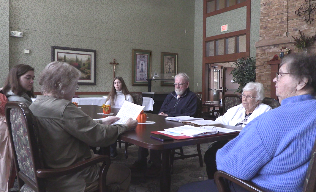 Member of storytelling group sit around table together